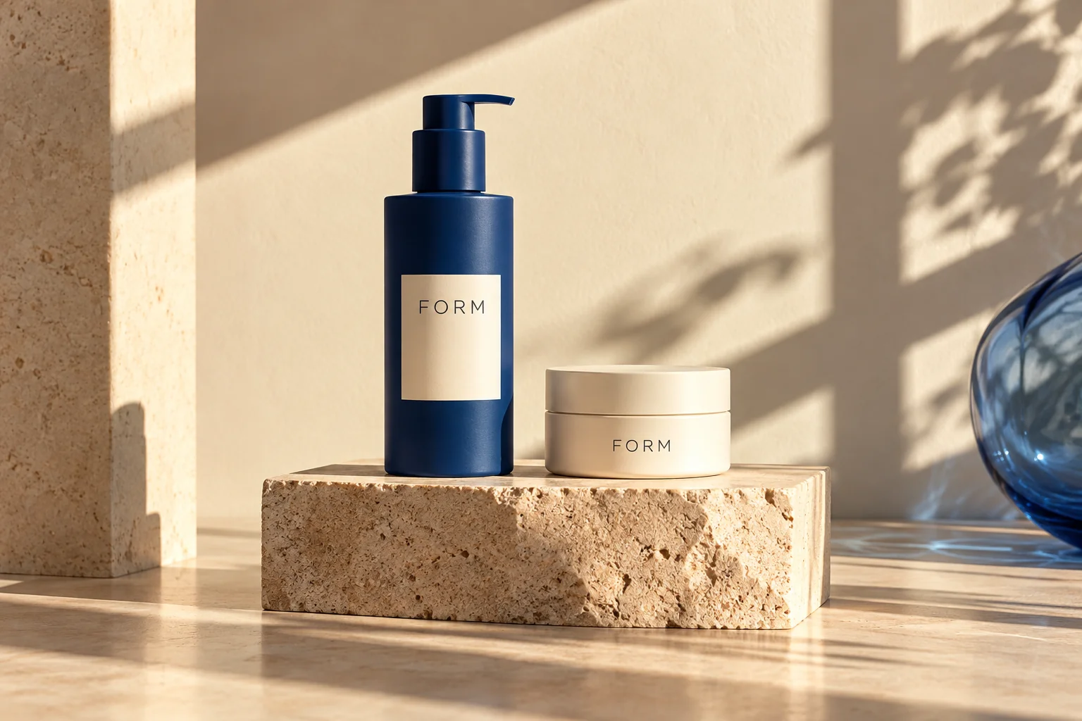 Fictional FORM skincare products in cobalt and cream on sunlit sandstone; an AI-generated concept study